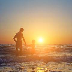 father and daughter at sunset