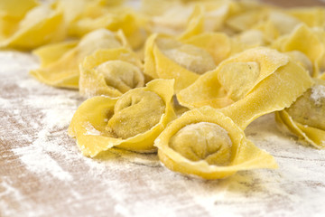 flouring tortellini ready to cook in the broth - 135608817