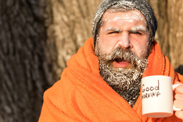 Man in blanket with cup
