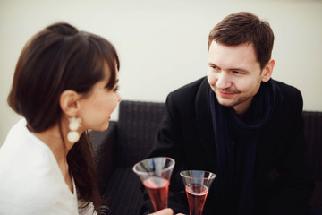 beautiful and young couple drinking champagne on terrace