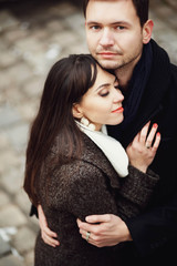 man and woman stands and hug each other outdoors