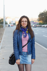 Cheerful girl walking and poses through street