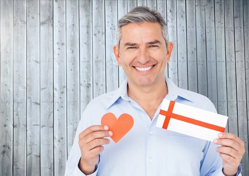 Portrait Of Senior Man Holding Red Heart And Gift Card