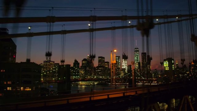 Driving over Manhattan Bridge overlooking Brooklyn Bridge and Manhattan downtown