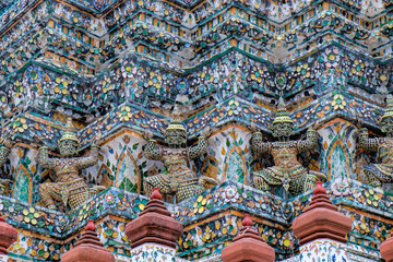 Fototapeta na wymiar Demon Guardian Statues at pagoda of Temple of Dawn, Wat Arun, Bangkok, Thailand. Magnificent Architecture of Wat Arun