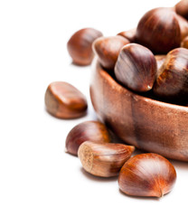 sweet  chestnut in wooden plate isolated on white background