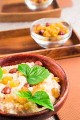 Oatmeal with berries, raisins and herbs with blur