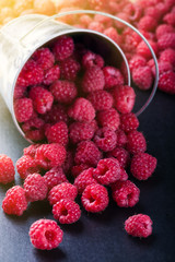 A bucket with scattered berries