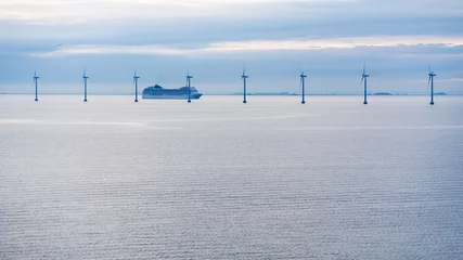 Fotobehang ferry near offshore wind farm in morning twilight © vvoe