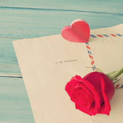 Vintage love letter, wood heart and red rose