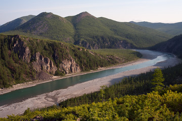 Top view of the beautiful river in the mountains. River Omulevka. Magadan Region. Russia.