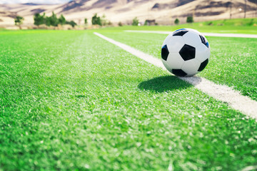 Fototapeta premium Traditional soccer ball on soccer field