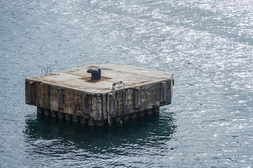 Concrete buoy, quay in the sea - moor for boats