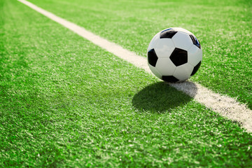 Traditional soccer ball on soccer field