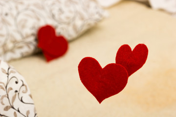 Fototapeta premium Small red heart from felt on linen