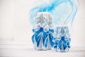St. Valentine's Day: two carved candles of blue color against the background   heart.