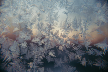 hoarfrost at a window against the background of decline dawn