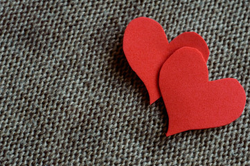 two red hearts wrapped in knitted fabric