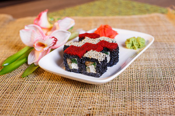 traditional fresh japanese sushi rolls on a black background