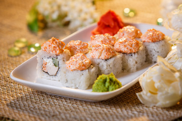 Traditional sushi rolls made of rice with caviar and sauce