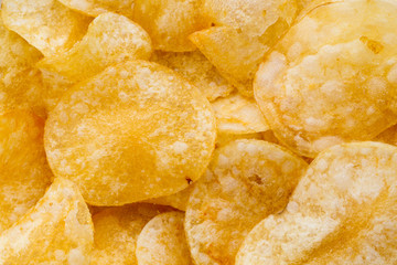 Close up potato chips on wood top view background.