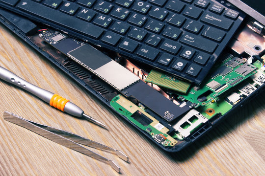 Screwdrivers and disassembled computer