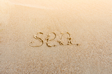 Fototapeta na wymiar The inscription on the sand of the sea