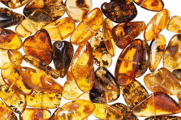 Yellow amber stones on a white background.