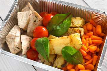 Healthy food in boxes, diet concept. Steamed turkey with vegetables