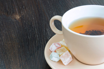 Cup of black tea on the dark background