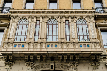 Fototapeta na wymiar Building facade: Old style windows, balcony. Barcelona. Spain.