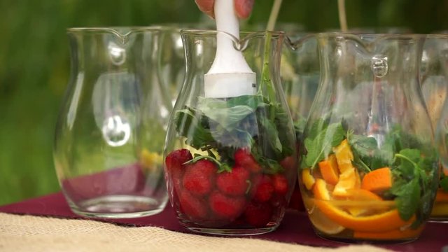 Create strawberry lemonade, mash the berries.