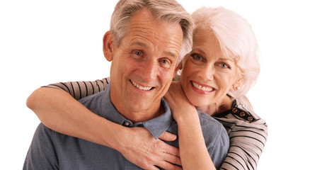 Happy senior couple smiling at camera on white background