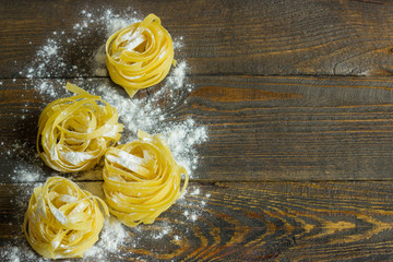 pasta tagliatelle with flour on table