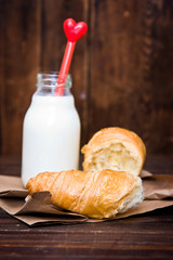 Bottle of milk and croissant