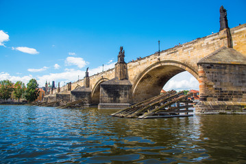 Fototapeta na wymiar Charles Bridge and Wooden icebreaker on the Vltava river in Prague