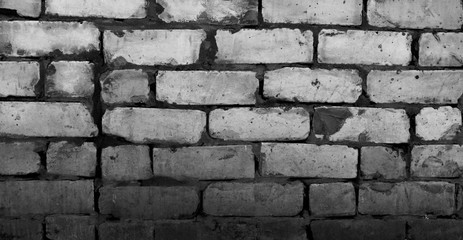 The texture of the brickwork. Roughly stacked bricks. Horizontal background.