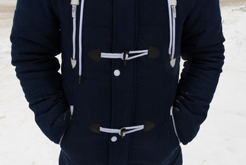 Detail of a man's torso in a fashionable winter jacket. Blue parka.