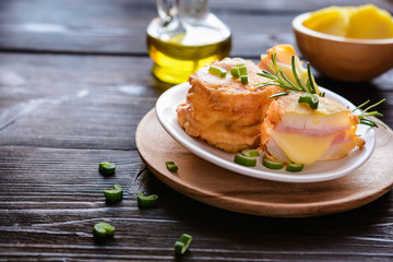 Fried onion slices in batter, stuffed with ham and cheese