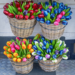 Colorful wooden artificial tulips in baskets