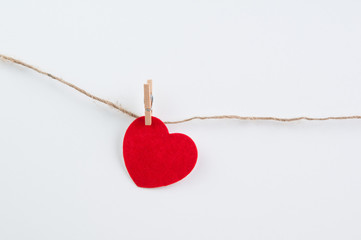 One red felt heart pinned to twine