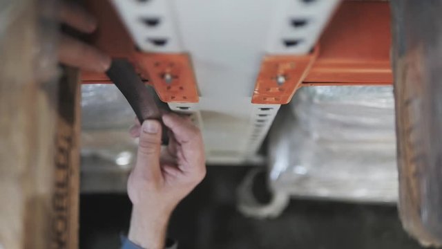 Male's Hands With Precision Measuring Tool. Engineer Makes Measurement of The Beam At The Storage, Close Up Shot