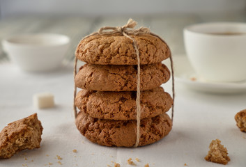 Homemade oat cookies with coffee on a wooden background