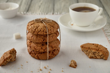 Homemade oat cookies with coffee on a wooden background