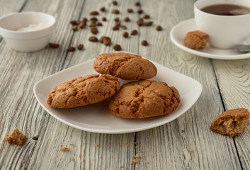 Homemade oat cookies with coffee on a wooden background