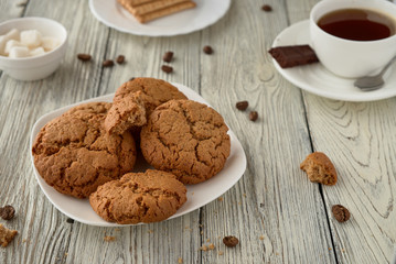 Homemade oat cookies with coffee on a wooden background