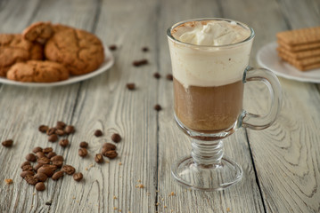Viennese coffee with oat cookies on a wooden background