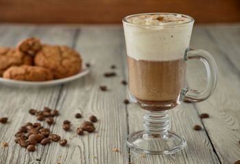 Viennese coffee with oat cookies on a wooden background