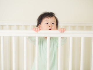 Baby girl in cot bed