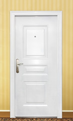 Flat front view of a family home door. White color. Yellow color wall.
